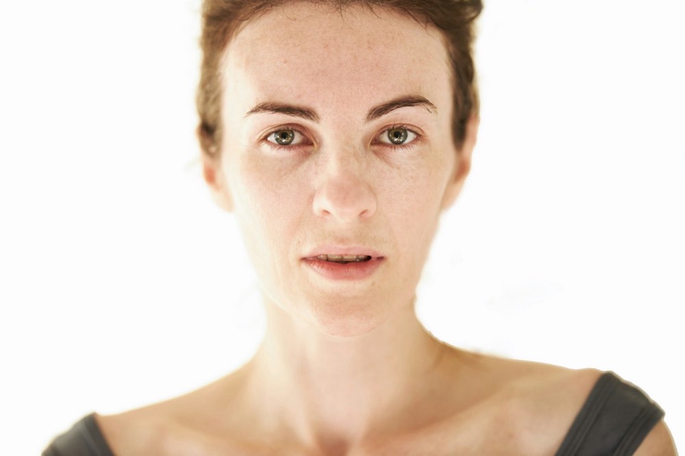 A close portrait of a woman looking directly at the camera